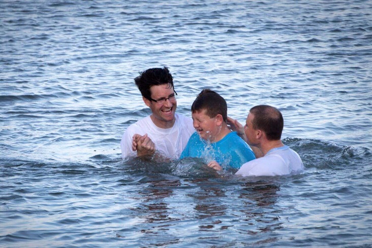 Marshall Greene (center) is baptized during the Annual Inlet Baptism in Murrells Inlet off the Belin Memorial United Methodist Church's seawall. Holding him is (left) Austin Bond, director of youth ministries and (right) Walter Cantwell, associate pastor. Photo by Benjamin Coy