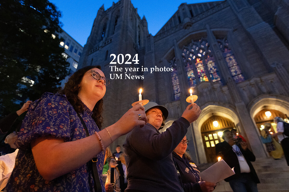 On the eve of the 2024 United Methodist General Conference in Charlotte, N.C., climate activists hold a candlelight Vigil for Creation to mark Earth Day and to call the denomination to greater stewardship of creation. Participants included Mary Frances Gaston (left) Emily McGinn, students at the Candler School of Theology in Atlanta. The service took place at the First United Methodist Church of Charlotte. Photo by Mike DuBose, UM News.