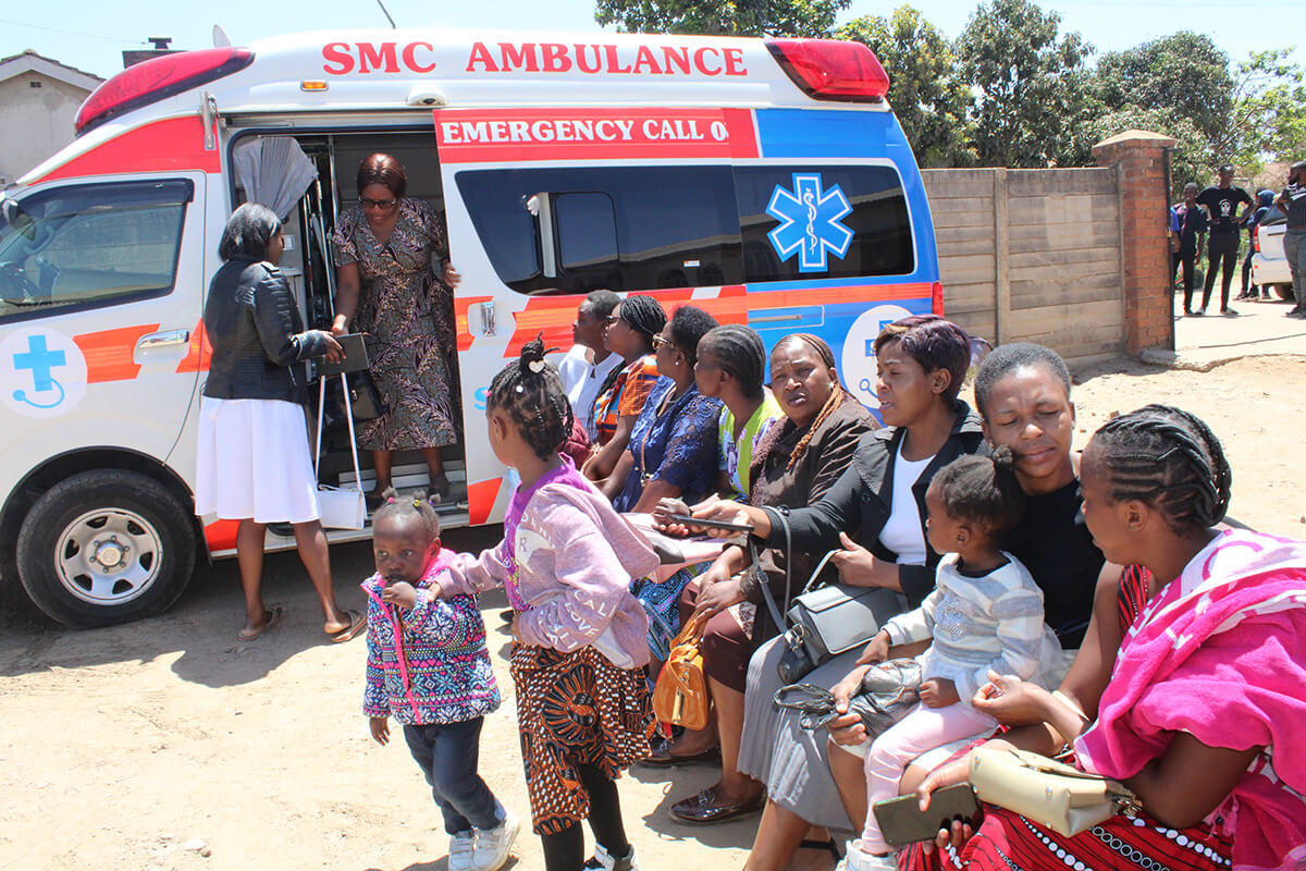 A woman exits an ambulance after receiving testing during The United Methodist Church’s free health expo in Harare, Zimbabwe, as other patients wait to be seen. The church partnered with the government and Sunningdale Medical Center to offer the free screenings to church members and the community in October. Photo by Kudzai Chingwe, UM News.