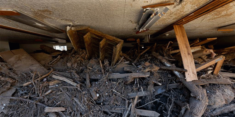 Debris caused by Hurricane Helene’s floodwaters fills the fellowship hall to within inches of the ceiling at Pensacola United Methodist Church in Burnsville, N.C. (Photo: Mike DuBose, UM News)