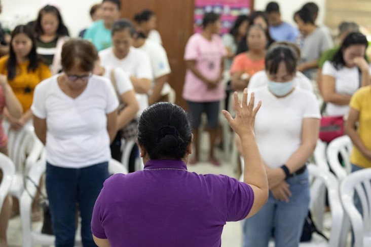 Bishop Estrella offers a prayer in the Philippines
