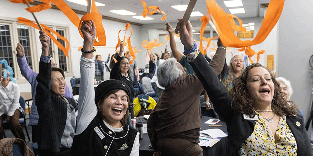 Members of the United Women in Faith Program Advisory Group celebrate the announcement of Assembly 2026, scheduled for May 15-17, 2026, in Indianapolis. Pictured in the foreground are board member Marilyn Sanchez Reid of the Western Jurisdiction and Vice President Heidi Careaga of the North Central Jurisdiction. Photo by Mike DuBose, UM News.