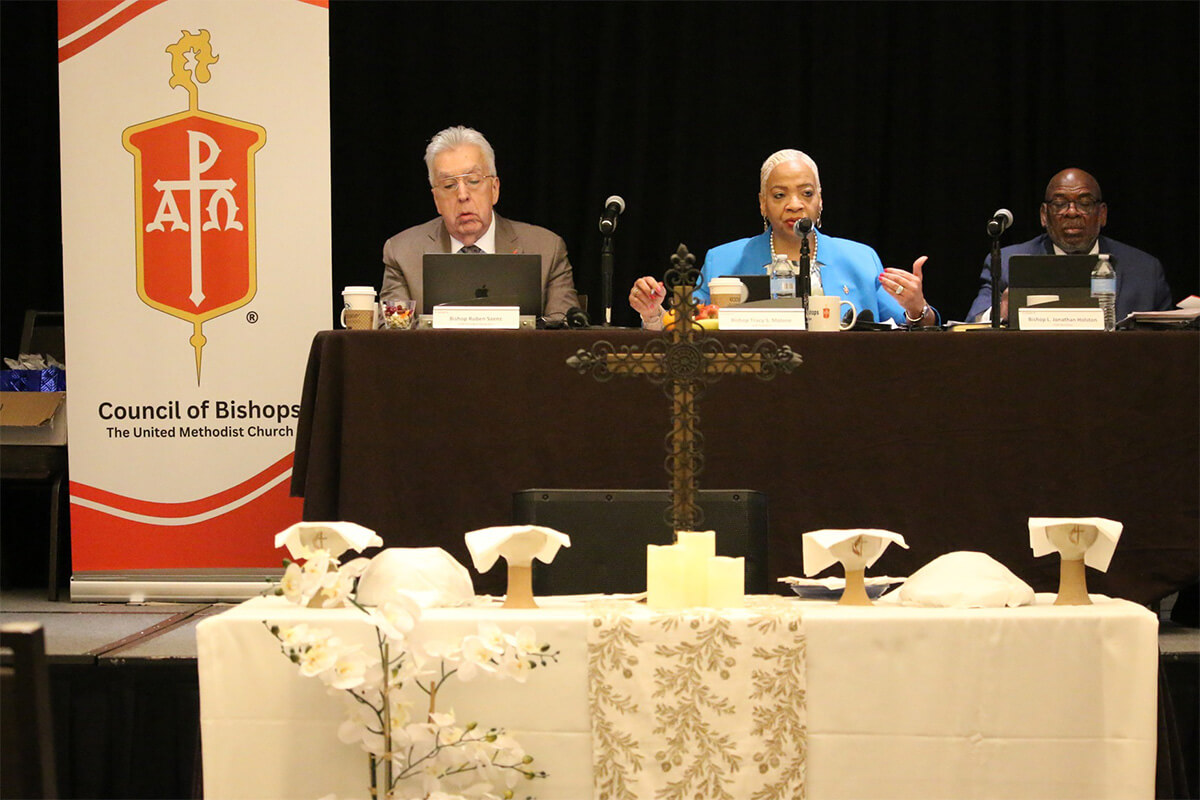 Council of President Tracy S. Malone (center), who also leads the Indiana Conference, addresses her fellow bishops and those watching on livestream on May 2, final day of the Council of Bishops 2025 spring meeting in Chicago. The bishops released a statement late that day trying to ease concerns about a Judicial Council ruling on same-sex weddings. Sitting beside Malone, from left, are Horizon Texas Conference Bishop Ruben Saenz Jr., president-designate, and Bishop L. Jonathan Holston, secretary. Holston leads the Alabama-West Florida and North Alabama conferences. Photo by Rick Wolcott, Council of Bishops.