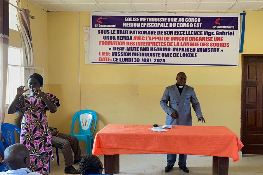 A member of Lokole United Methodist Mission in Kindu offers sign language interpretation during worship, helping make the service more inclusive. Photo by Chadrack Londe. A member of Lokole United Methodist Mission in Kindu offers sign language interpretation during worship, helping make the service more inclusive. Photo by Chadrack Londe.