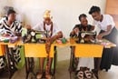 Estudantes de corte e desenho recebem instruções de Rute Uthui. O Projeto de Corte, Costura e Cozinha capacita mulheres e raparigas com conhecimentos que podem levar à geração de rendimentos.