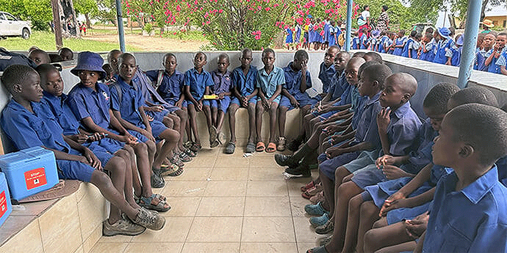 Schoolchildren from the United Methodist Chikwizo Primary School await their turn to get polio vaccines at Chikwizo rural health clinic in February. Polio is a killer disease affecting children under 10 years old. According to the World Health Organization, Zimbabwe is part of the Global Polio Eradication Initiative and has sustained high vaccination coverage with over 90% of children receiving vaccines. Photo by Eveline Chikwanah, UM News.