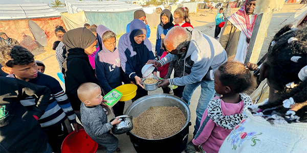 Hana's* family arrives at the camp gathering point for a hot, cooked meal. (Photo: IOCC) *names have been change Hana's* family arrives at the camp gathering point for a hot, cooked meal. (Photo: IOCC) *names have been change