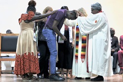 Steven Odhiambo of the Kenya-Ethiopia Conference is consecrated as a home missioner by retired United Methodist Bishop Joaquina F. Nhanala during the Africa Region Deaconess/Home Missioner consecration service on July 9 at the Lutheran Uhuru Hostel and Conference Centre in Moshi, Tanzania. The ceremony marked the first time a United Methodist deaconess/home missioner consecration was held on African soil. Photo courtesy of Laurel Akin.