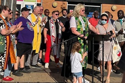 Some 40 faith leaders from across Washington, D.C., join Aug. 22 in leading a prayer vigil in the city’s ethnically diverse Columbia Heights neighborhood. The group aimed to present a vision of unity and hope in the face of Trump’s deployment of National Guard troops in the nation’s capital. At center in the green and white stole is the Rev. Donna Claycomb Sokol, pastor of Mount Vernon Place United Methodist Church, who spoke at the event. Photo by Sharon Groves, the Festival Center.