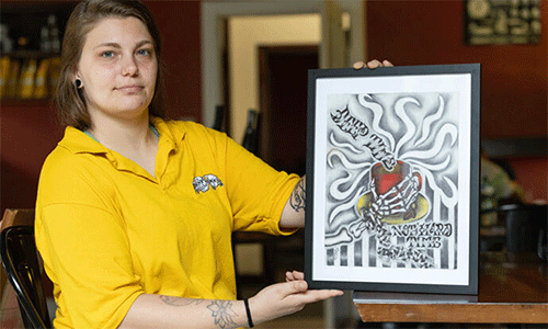 Destiny Varner displays artwork she created to help promote the Deep Time ministry in Asheville, N.C.