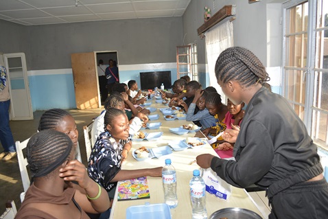 Orphans from the Jamaa Letu Center orphanage share a meal with students from the English-Speaking School of Lubumbashi. This moment of sharing is part of a generosity initiative, when the students visit the girls at the Jamaa Letu Center in Congo. Photo by Papy Dyanda Honoré
