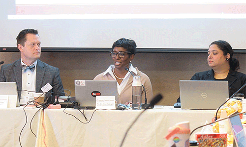The Rev. Aleze M. Fulbright (center) celebrates the growth of The United Methodist Church in Africa as the Commission on the General Conference, meeting in Minneapolis on Nov. 11, considers setting the number of delegates for the 2028 General Conference. Sitting beside Fulbright, the General Conference secretary, are the Rev. Andy Call, the commission’s chair, and Sharah Dass, General Conference business manager. Photo by Heather Hahn, UM News.
