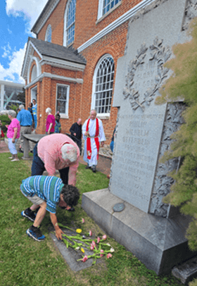 members of the congregation at Old Otterbein UMC placing flowers on Otterbein’s grave