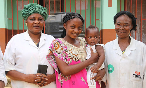 Marie Otshumba, one of the beneficiaries of The United Methodist Church’s Maternal, Newborn and Child Health program, holds son Amisi alongside nurses at Lokole United Methodist Hospital Center in Kindu, Congo. After five years of repeated miscarriages, Otshumba said the prenatal care she received through the church program transformed her pain into joy. Photo by Chadrack Tambwe Londe, UM News.